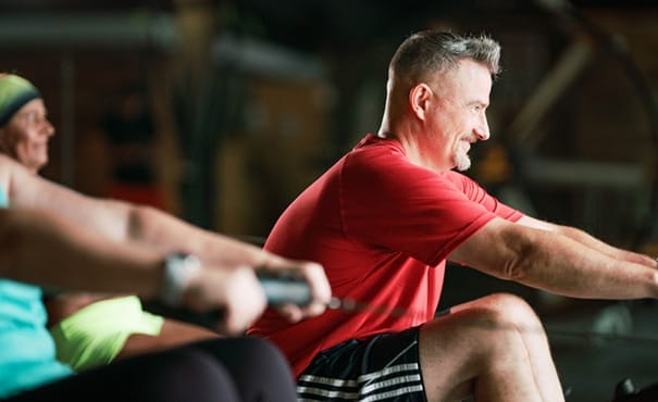 man working out on rower